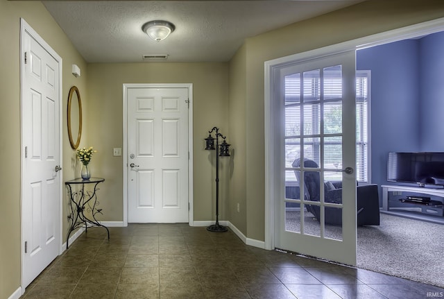 229 Ironwood Ln, Ossian, IN 46777 - foyer entrance featuring tile patterned floors, a textured ceiling, and baseboards