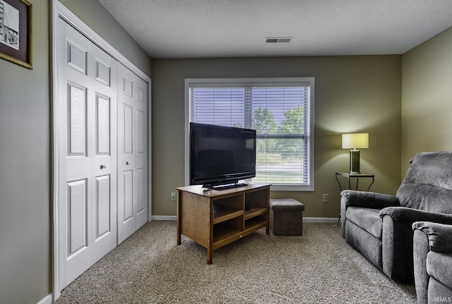 229 Ironwood Ln, Ossian, IN 46777 - carpeted living area with baseboards and a textured ceiling