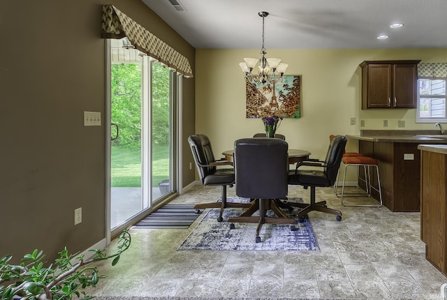 229 Ironwood Ln, Ossian, IN 46777 - dining area featuring baseboards, a chandelier, and light stone finish floors