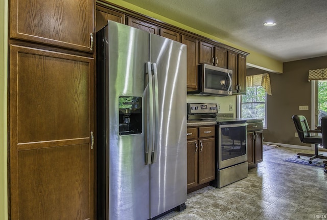 229 Ironwood Ln, Ossian, IN 46777 - kitchen with appliances with stainless steel finishes, a textured ceiling, baseboards, and recessed lighting