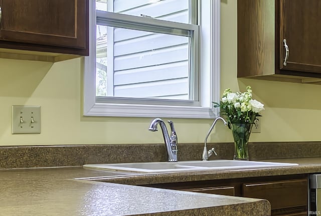 229 Ironwood Ln, Ossian, IN 46777 - kitchen view of dark brown cabinetry, a sink, and dark countertops