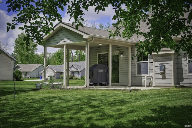 229 Ironwood Ln, Ossian, IN 46777 - rear view of house featuring a yard and a shingled roof