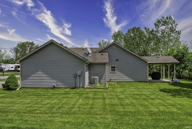 229 Ironwood Ln, Ossian, IN 46777 - rear view of property featuring central AC, a yard, and a shingled roof
