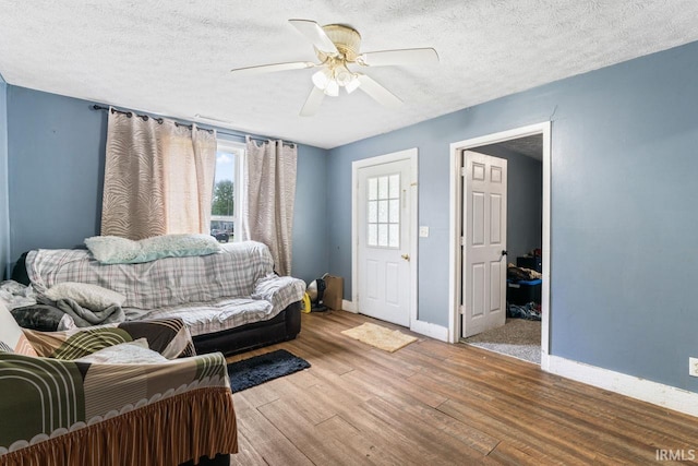 2320 Rogers St, Lafayette, IN 47905 - living area featuring wood finished floors, baseboards, a ceiling fan, and a textured ceiling