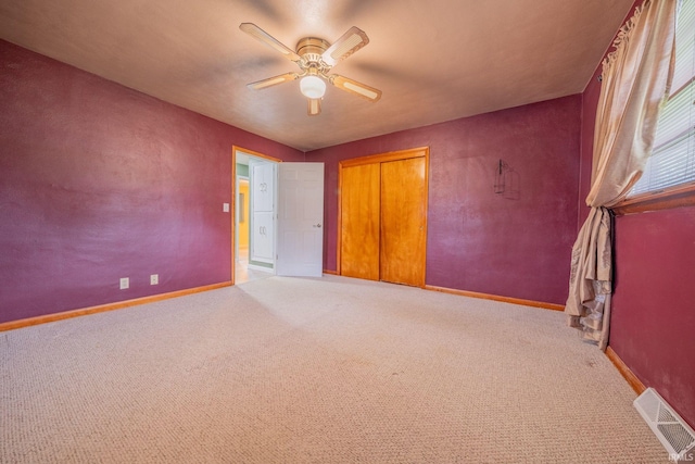 902 Hawthorne Ln, Logansport, IN 46947 - unfurnished bedroom featuring carpet floors, baseboards, a ceiling fan, and a closet