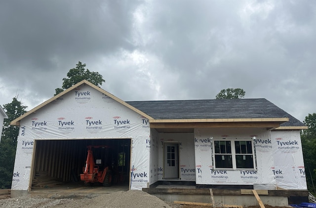 910 S Lantern Ln, Ellettsville, IN 47429 - unfinished property featuring covered porch, an attached garage, and a shingled roof