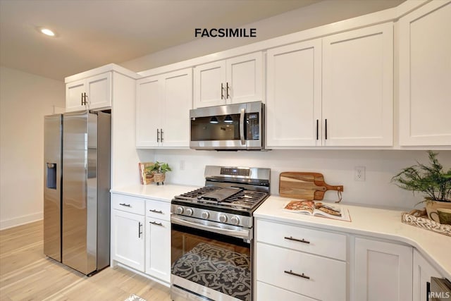 910 S Lantern Ln, Ellettsville, IN 47429 - kitchen featuring appliances with stainless steel finishes, light countertops, white cabinetry, light wood-type flooring, and recessed lighting