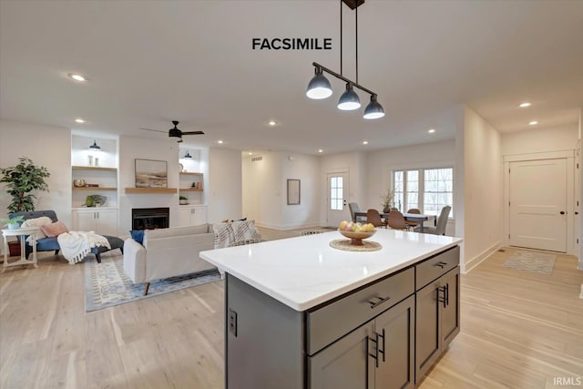 910 S Lantern Ln, Ellettsville, IN 47429 - kitchen featuring gray cabinetry, a kitchen island, light wood-style floors, ceiling fan, and recessed lighting