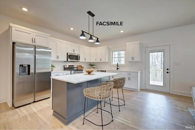 910 S Lantern Ln, Ellettsville, IN 47429 - kitchen with appliances with stainless steel finishes, a sink, white cabinets, a center island, and recessed lighting