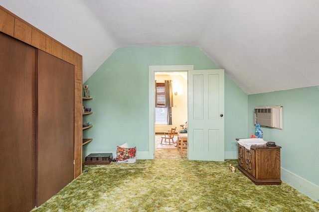 222 Queen St, Goshen, IN 46528 - additional living space with lofted ceiling, carpet, baseboards, and an AC wall unit