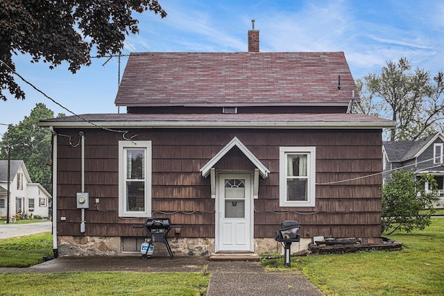 222 Queen St, Goshen, IN 46528 - view of front of house featuring a chimney and a front lawn