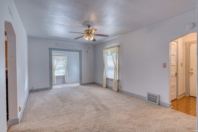 517 W Locust St, Boonville, IN 47601 - carpeted spare room featuring arched walkways, a ceiling fan, a smoke detector, and baseboards