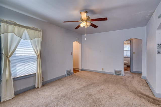 517 W Locust St, Boonville, IN 47601 - carpeted spare room with arched walkways, a ceiling fan, and baseboards