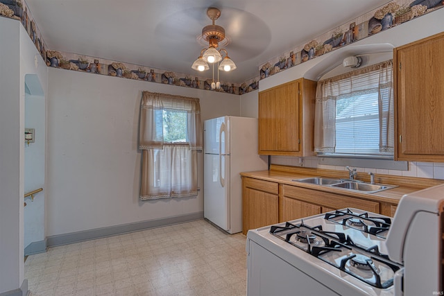517 W Locust St, Boonville, IN 47601 - kitchen featuring a sink, light floors, white appliances, light countertops, and ceiling fan