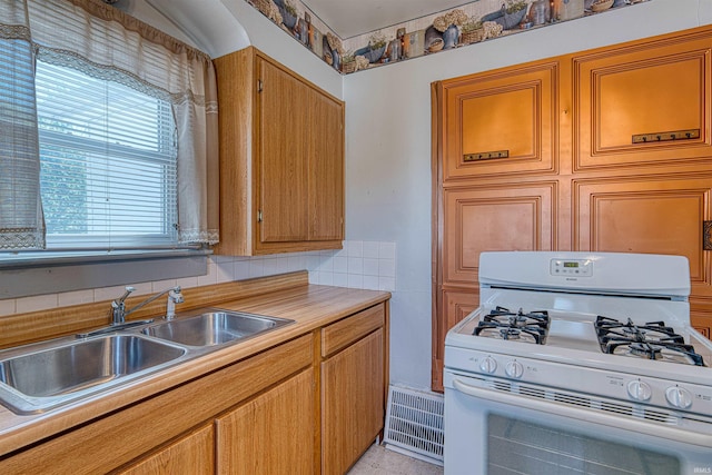 517 W Locust St, Boonville, IN 47601 - kitchen featuring white gas stove, a sink, and light countertops