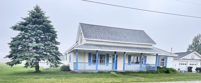 12537 E 340 S, Greentown, IN 46936 - view of front of property with covered porch, a front yard, a garage, and roof with shingles