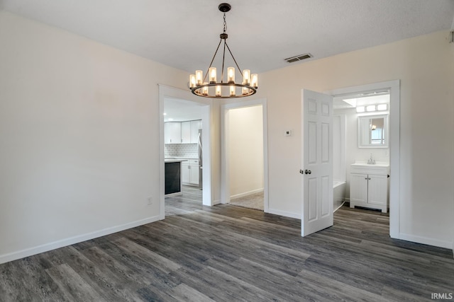 355 Blinn Ave, Frankfort, IN 46041 - unfurnished dining area featuring dark wood-type flooring, a chandelier, and baseboards