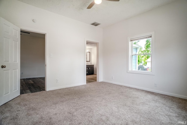355 Blinn Ave, Frankfort, IN 46041 - unfurnished bedroom with carpet, baseboards, connected bathroom, and a ceiling fan