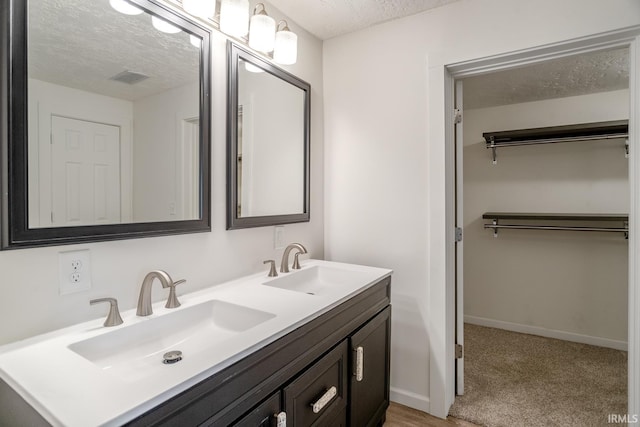 355 Blinn Ave, Frankfort, IN 46041 - full bathroom with a textured ceiling, double vanity, and baseboards