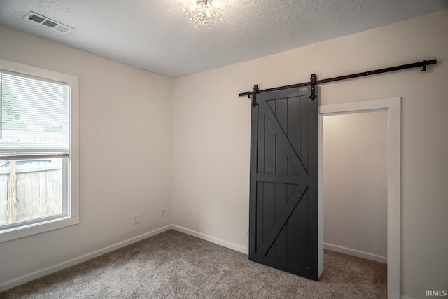 355 Blinn Ave, Frankfort, IN 46041 - unfurnished bedroom featuring multiple windows, carpet flooring, baseboards, and a textured ceiling
