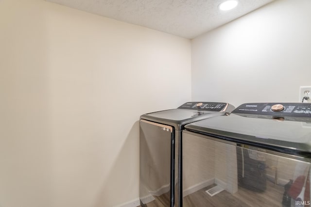 355 Blinn Ave, Frankfort, IN 46041 - laundry area featuring separate washer and dryer, a textured ceiling, baseboards, wood finished floors, and recessed lighting