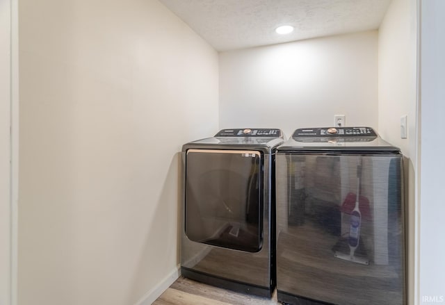 355 Blinn Ave, Frankfort, IN 46041 - laundry room featuring washer and dryer, light wood-style floors, baseboards, and a textured ceiling