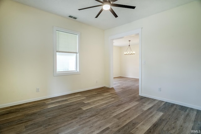 355 Blinn Ave, Frankfort, IN 46041 - unfurnished room with a ceiling fan, dark wood-style floors, a chandelier, and baseboards