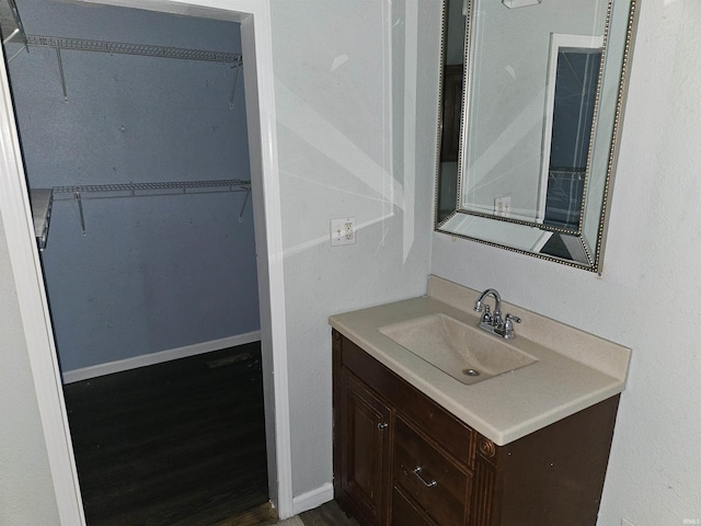 808 N 9th St, Vincennes, IN 47591 - bathroom featuring vanity, wood finished floors, and a walk in closet
