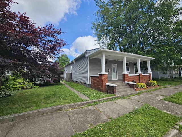 808 N 9th St, Vincennes, IN 47591 - view of front of property featuring covered porch, central air condition unit, and a front lawn