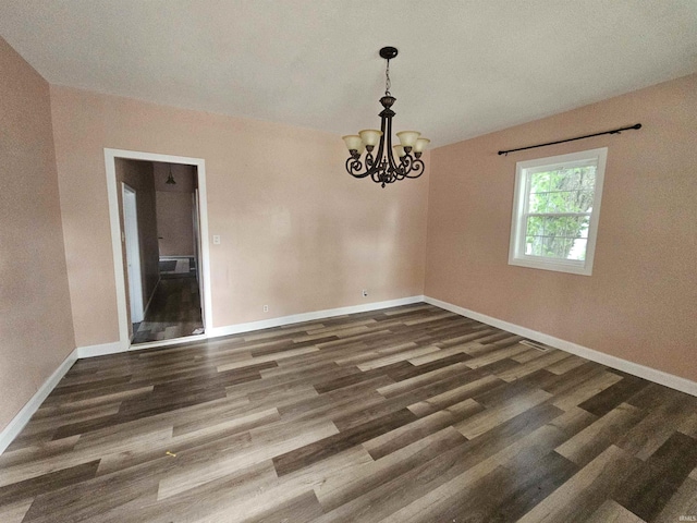 808 N 9th St, Vincennes, IN 47591 - empty room featuring a chandelier, baseboards, and wood finished floors