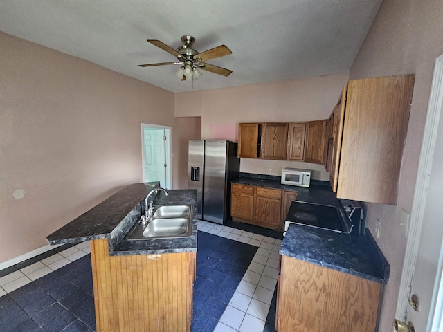 808 N 9th St, Vincennes, IN 47591 - kitchen with white microwave, stainless steel refrigerator with ice dispenser, stove, a sink, and ceiling fan