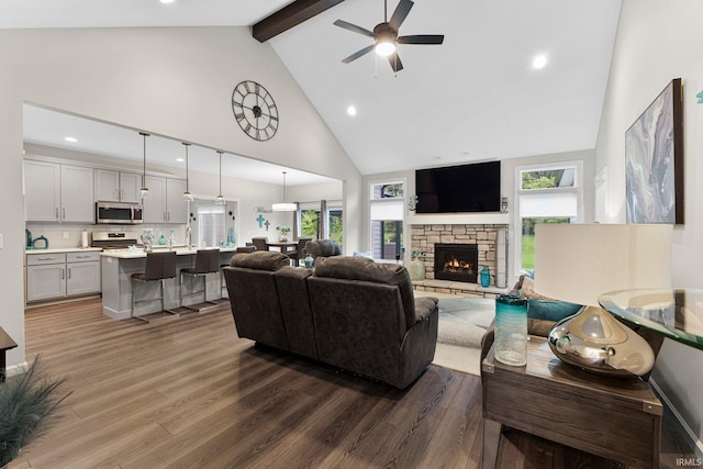 15332 Annabelle Pl, Leo, IN 46765 - living area featuring wood finished floors, beamed ceiling, high vaulted ceiling, ceiling fan, and a fireplace