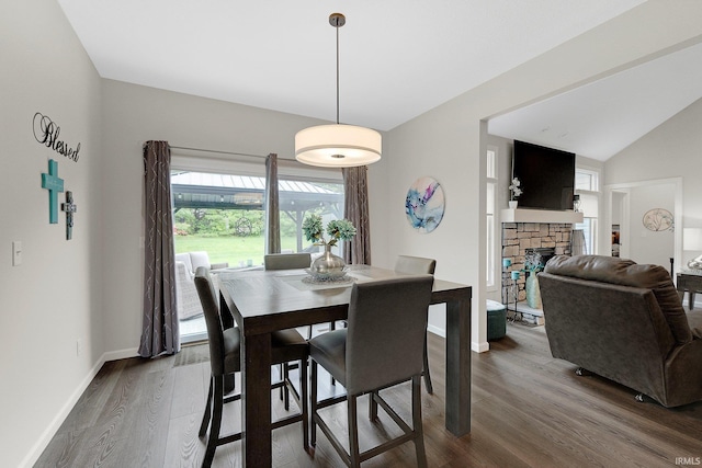15332 Annabelle Pl, Leo, IN 46765 - dining space with dark wood-style floors, baseboards, a fireplace, and vaulted ceiling