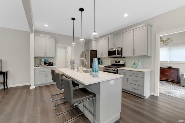 15332 Annabelle Pl, Leo, IN 46765 - kitchen with stainless steel appliances, gray cabinetry, decorative backsplash, wood finished floors, and recessed lighting