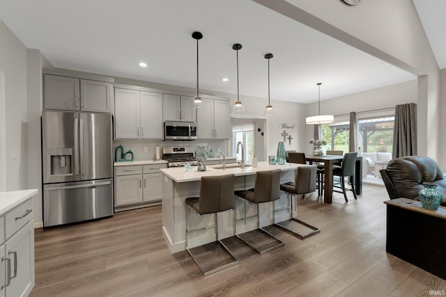 15332 Annabelle Pl, Leo, IN 46765 - kitchen featuring appliances with stainless steel finishes, light countertops, light wood finished floors, decorative backsplash, and recessed lighting