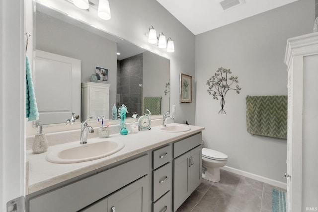 15332 Annabelle Pl, Leo, IN 46765 - bathroom featuring double vanity, a tile shower, toilet, tile patterned floors, and baseboards