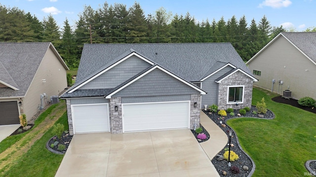 15332 Annabelle Pl, Leo, IN 46765 - craftsman-style house with stone siding, concrete driveway, a garage, and a front lawn