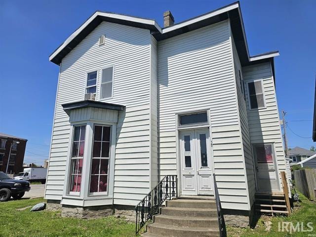 58 E 5th St, Peru, IN 46970 - back of property featuring entry steps and a chimney