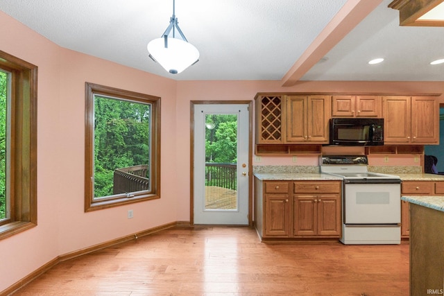 2711 Spring Creek Dr, Fort Wayne, IN 46808 - kitchen with black microwave, white electric range, light wood finished floors, baseboards, and pendant lighting