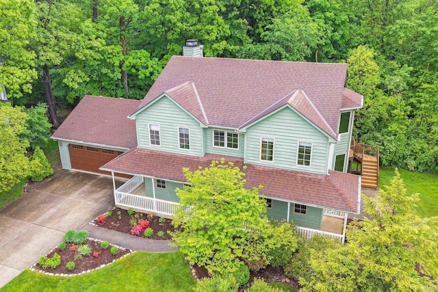 2711 Spring Creek Dr, Fort Wayne, IN 46808 - view of front of home with stairway, a chimney, driveway, an outdoor structure, and a wooded view