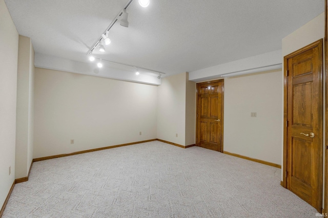 2711 Spring Creek Dr, Fort Wayne, IN 46808 - finished below grade area featuring track lighting, light colored carpet, and baseboards
