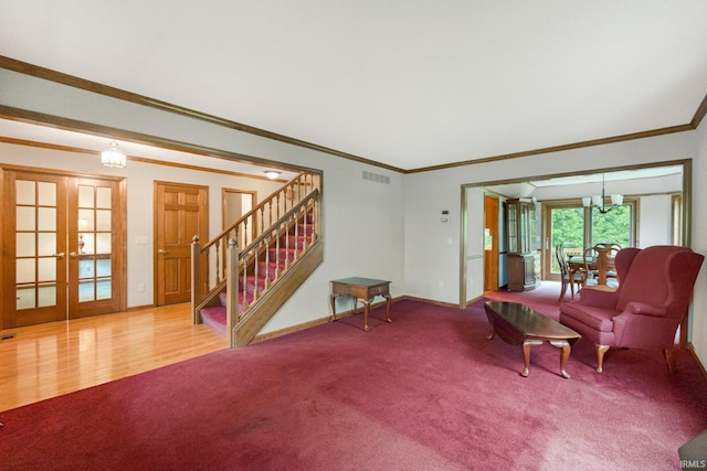 2711 Spring Creek Dr, Fort Wayne, IN 46808 - carpeted living area with ornamental molding, stairway, french doors, baseboards, and a chandelier