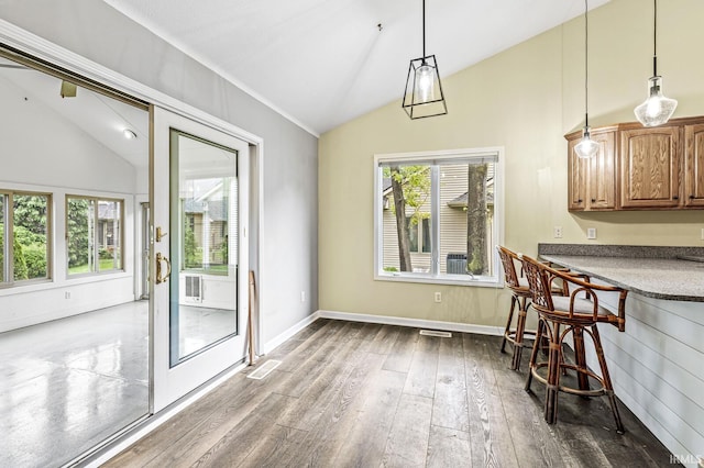 1224 Foxglove Ct, Mishawaka, IN 46545 - dining area with vaulted ceiling, dark wood-style flooring, and baseboards
