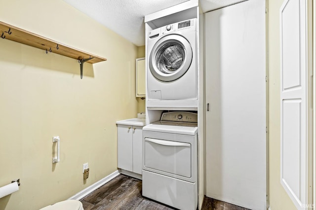 1224 Foxglove Ct, Mishawaka, IN 46545 - washroom featuring stacked washing machine and dryer, dark wood-type flooring, baseboards, and a textured ceiling