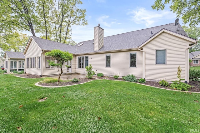 1224 Foxglove Ct, Mishawaka, IN 46545 - back of house featuring a chimney, a patio area, a yard, and a shingled roof