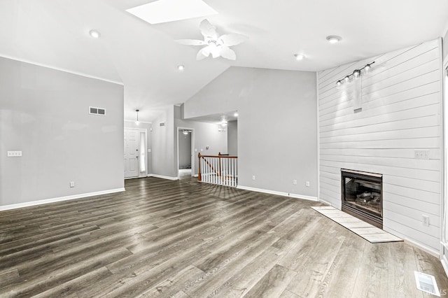 1224 Foxglove Ct, Mishawaka, IN 46545 - unfurnished living room featuring a large fireplace, ceiling fan, a skylight, wood finished floors, and high vaulted ceiling