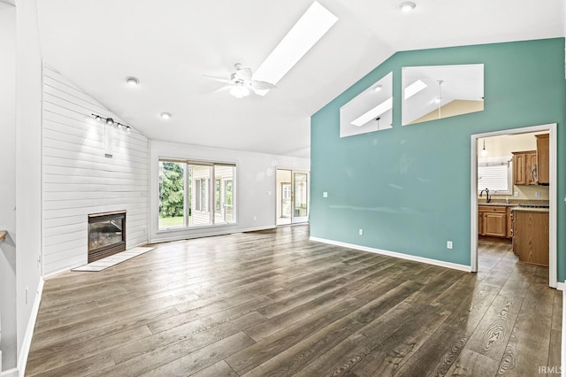 1224 Foxglove Ct, Mishawaka, IN 46545 - unfurnished living room with dark wood finished floors, a ceiling fan, high vaulted ceiling, a fireplace, and baseboards