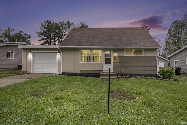 4113 York Rd, South Bend, IN 46614 - view of front of home with an attached garage, concrete driveway, a yard, board and batten siding, and roof with shingles