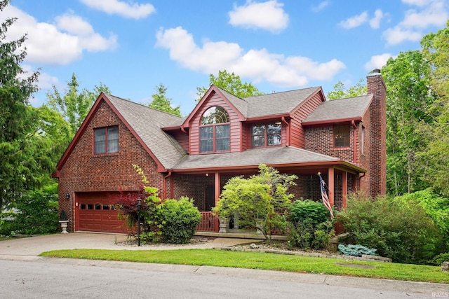 9982 S Saint Andrews Ln, Bloomington, IN 47401 - view of front of property with an attached garage, a chimney, covered porch, concrete driveway, and brick siding