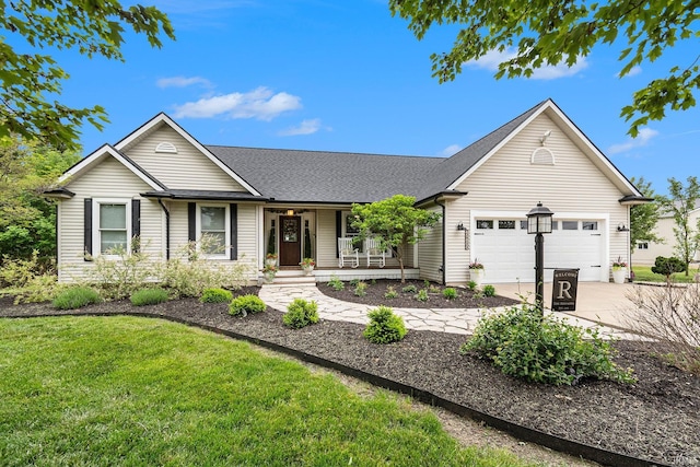 65600 Ash Rd, Wakarusa, IN 46573 - ranch-style home featuring a porch, an attached garage, driveway, a front yard, and roof with shingles